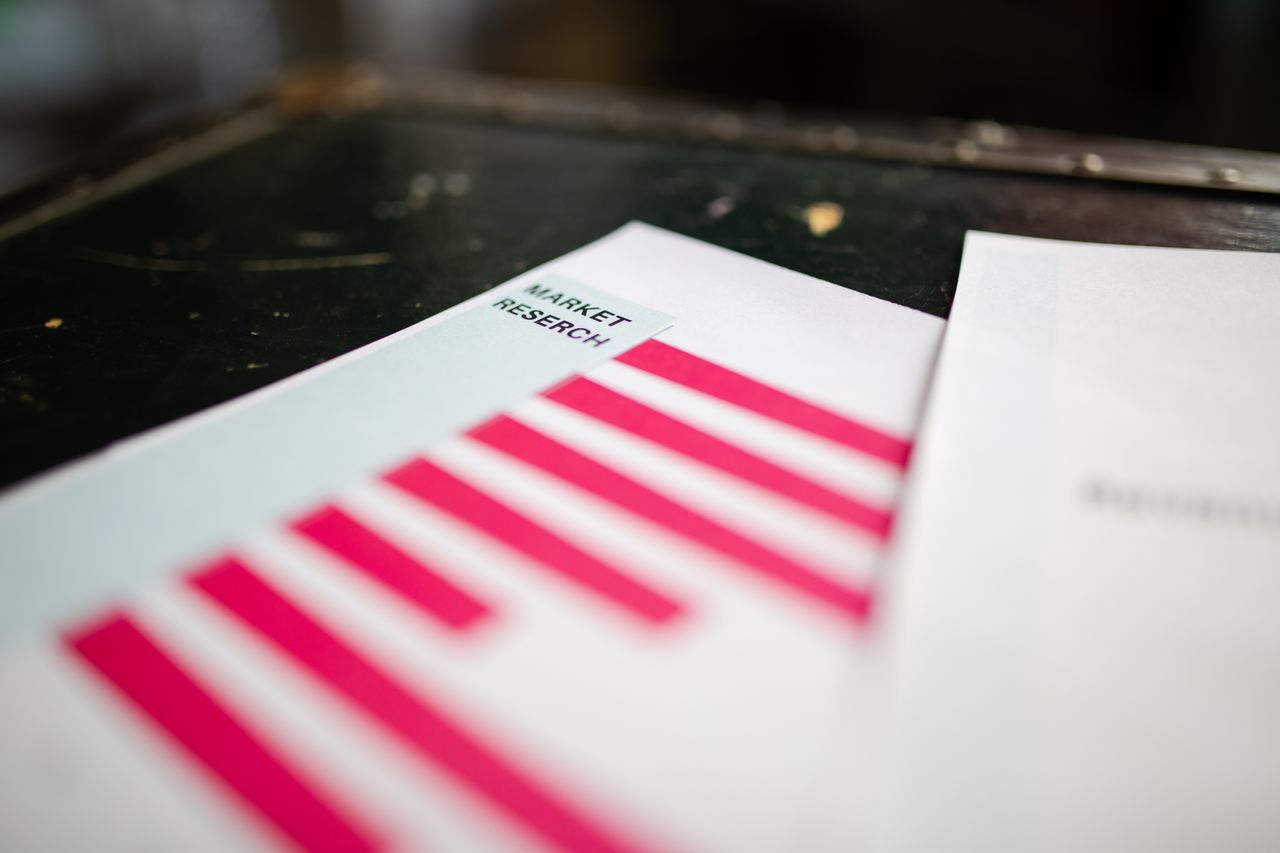 services-01 A detailed close-up of a market research document featuring a bar graph and a focus on market trends.